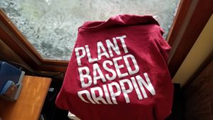 t-shirt sitting on a table with plant based drippin on it