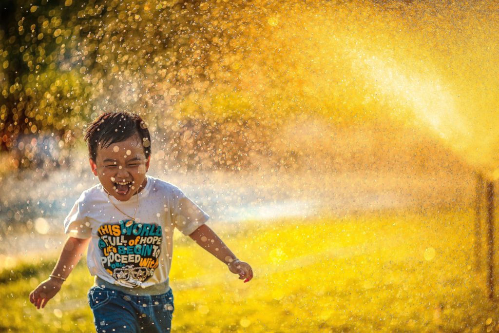 child running through water