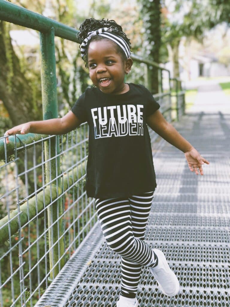 A cute girl wearing a future leader t-shirt.
