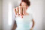 woman showing fist with I am Badass ring.