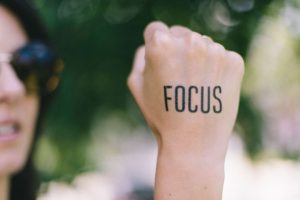 fist with the word focus written on it.