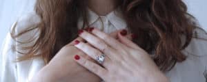 woman with hands crossed against her heart. Find your purpose and make a difference. Align your vales with action.