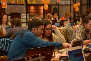 Man helping female students with a computer problem action plan example