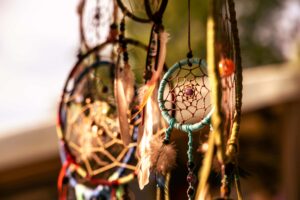 Indigenous dreamcatchers in several sizes and colors hang.