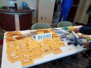 A seed library table covered with bean seed packets. Wild seeds.