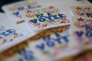 Colorful signs that say Be a Voter. Social change definitions.