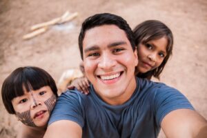 Man taking selfie with a boy and girl during compassionate tourism