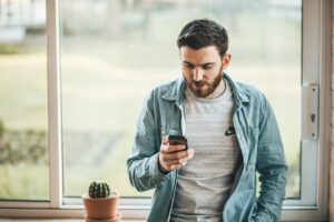 White man talking to his phone. Greater good meaning post.