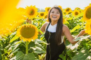 Smiling happy activist in a field of sunflowers.