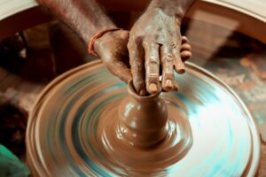 Hands working on a pottery wheel. Turn your skills into activism impact.