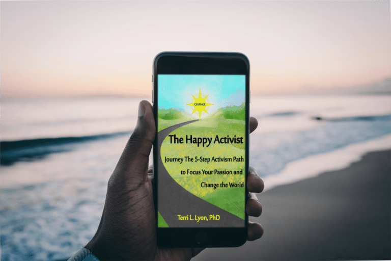 Hand holding a phone with The Happy Activist cover
