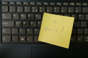 A keyboard with a post-it note reading "I quit." Be a happy activist.