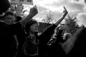 Black and white photo of protestors gesturing with birds.
