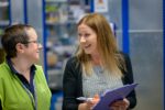 A woman with a clipboard petition speaks with another person about how to create a petition and how petitions change laws. Petition definition.