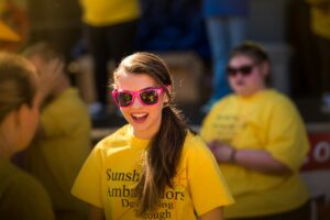 Two young women from the Sunshine Ambassadors dance at a NAMI walk. Change the world and give your legacy meaning. Volunteer, give back, and be the change you wish to see in the world.