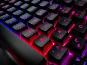 Black keyboard with blue, purple, and red lights, Rumi life Rumi quote brain health.