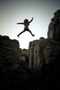 A woman jumps a gap in a canyon. Find my cause, the one closest to my heart.