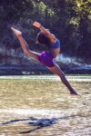 An African American dancer leaps into water. How to become an activist. Activism defined. Define grass roots. Movement defined.