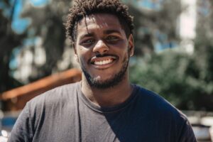 A smiling black man, credit union benefits